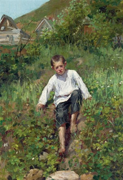 A boy climbing down a bank