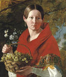 Portrait of a young woman holding a basket of grapes